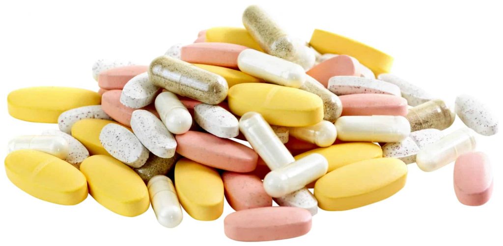 multiple coloured vitamins on white background